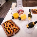 Our mimosa bar from our brunch board event. Two pitchers of OJ, two bottles of champaigne and a board of fruit screwers