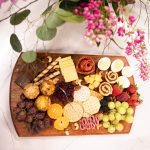 shot overtop of our brunch boards featuring muffins, fruit, grapes, and cinnamon rolls.