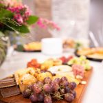 close up of grapes on a cheese board