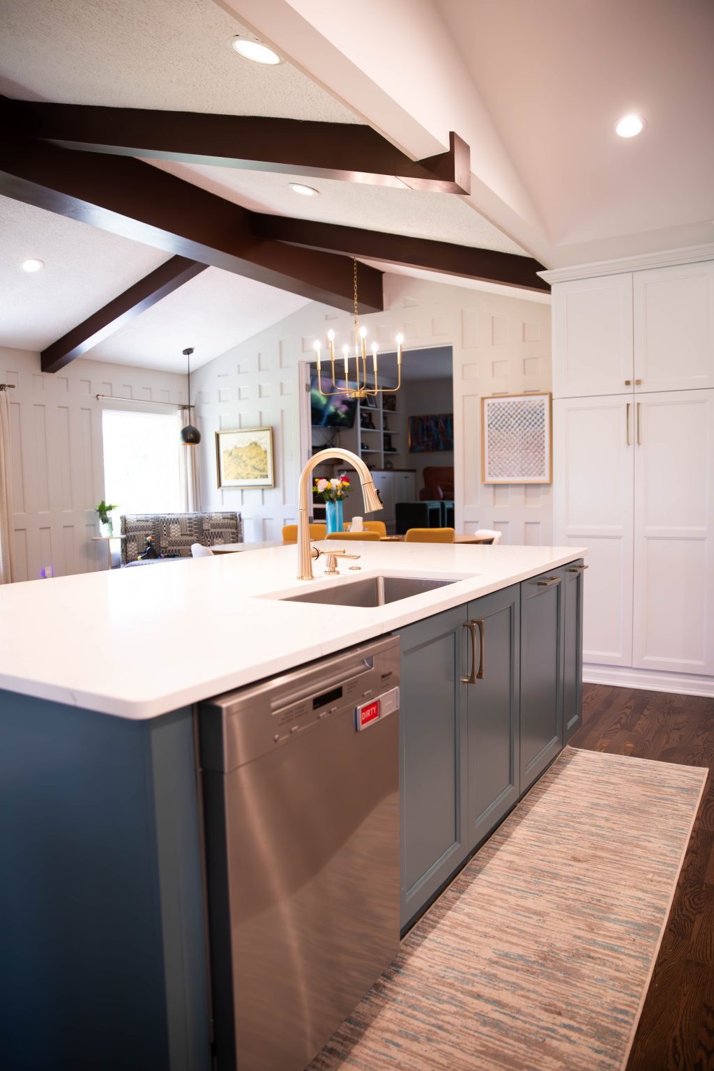 Blue island with sink, cabinet storage and stainless steel appliances installed by kitchen remodeler in Ottawa Hills