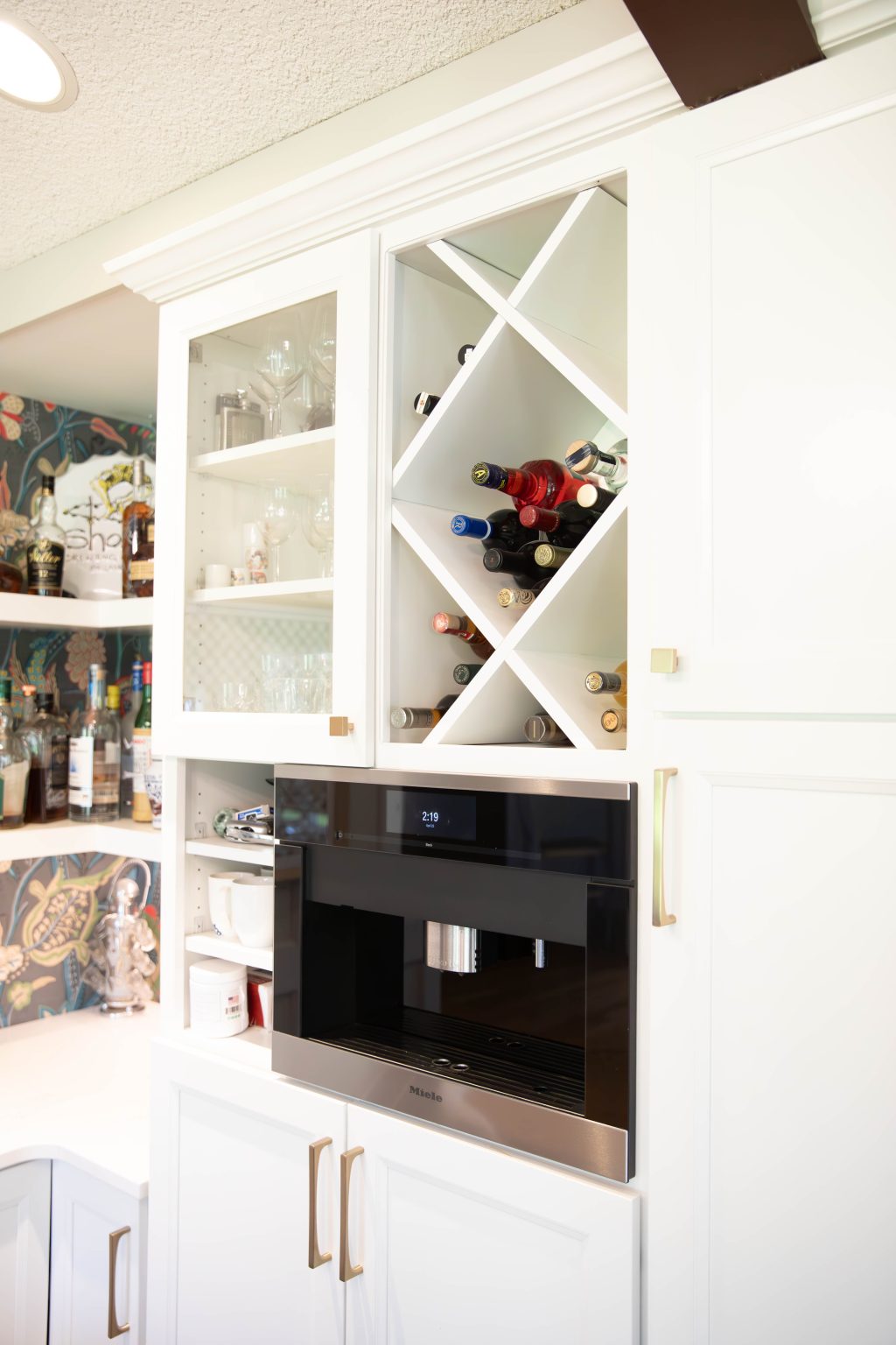 White storage racks for wine built into the cabinetry in a remodeled kitchen in Ottawa Hills