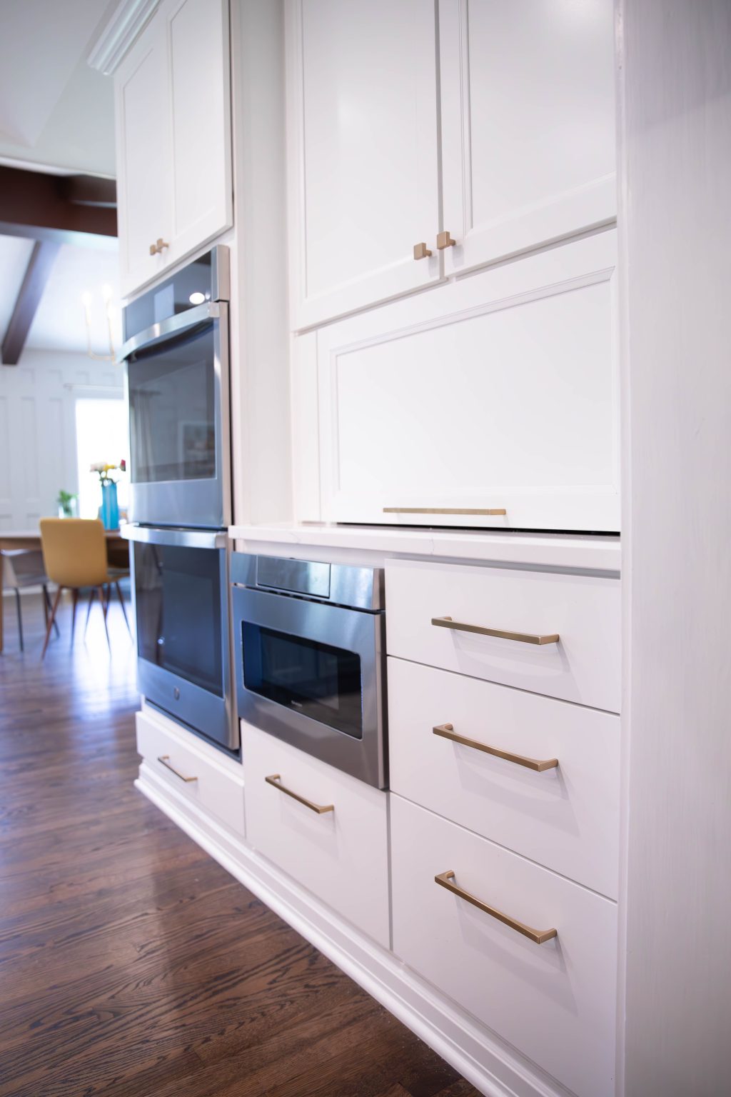 Dual oven and microwave built into a wall of white cabinets, installed by kitchen remodeler in Ottawa Hills