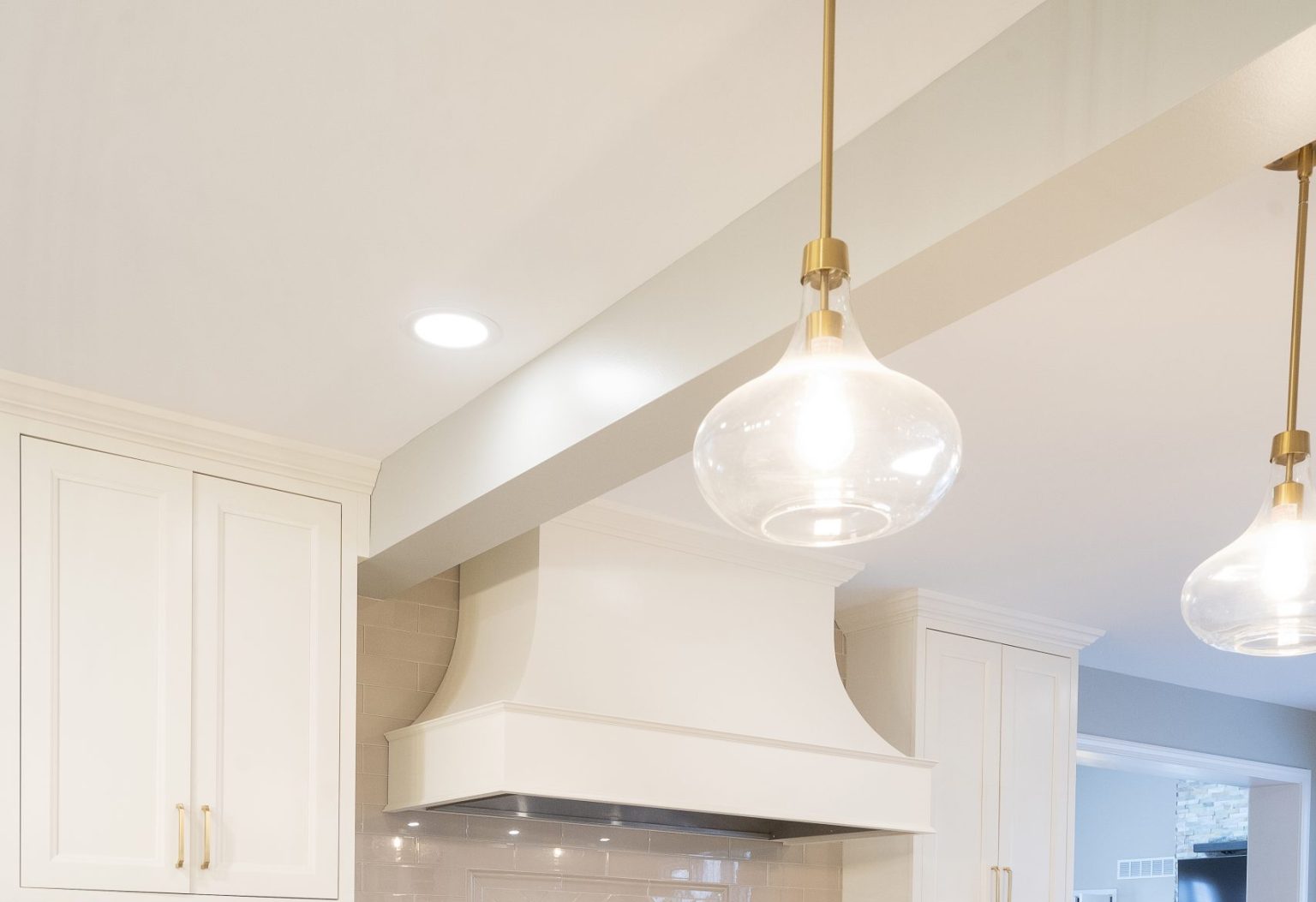 Stylish kitchen lighting with gold pendant lights and recessed lighting installed by Ottawa Hills kitchen remodeler